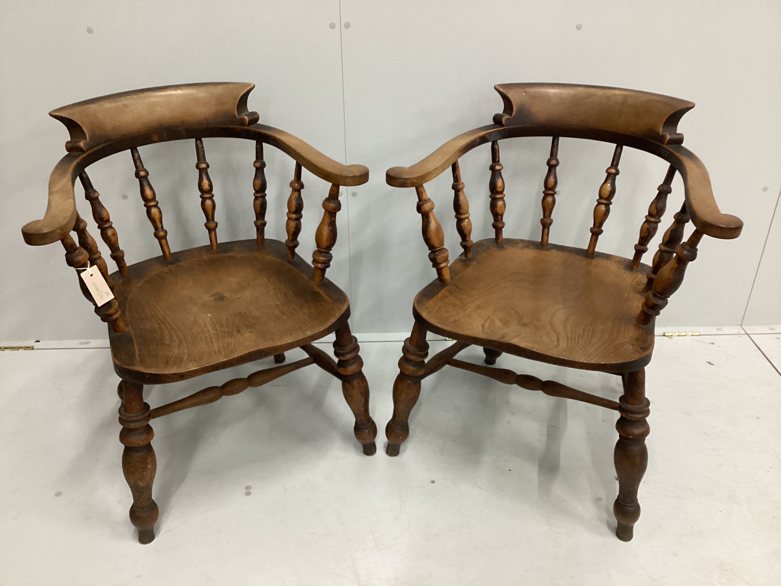 A pair of Victorian elm and beech smoker's bow elbow chairs, width 67cm, depth 50cm, height 82cm